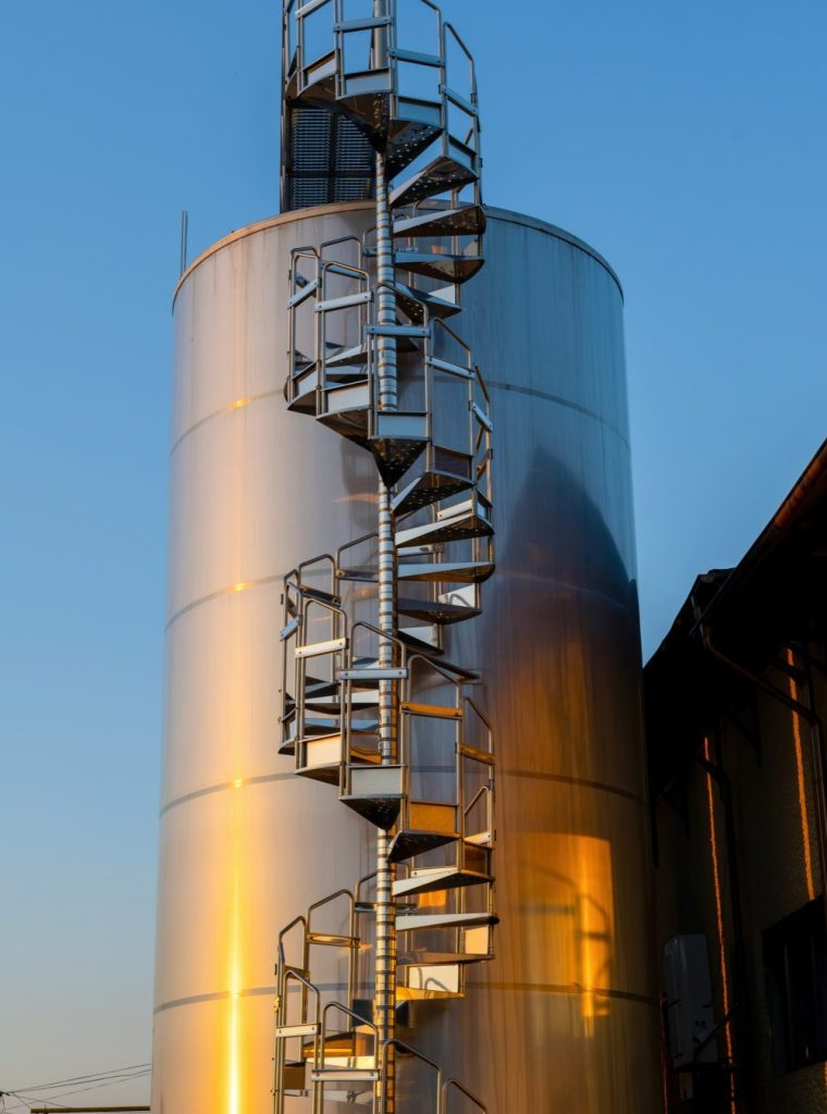 backyard-winery-sunset-with-metal-wine-storage-tanks